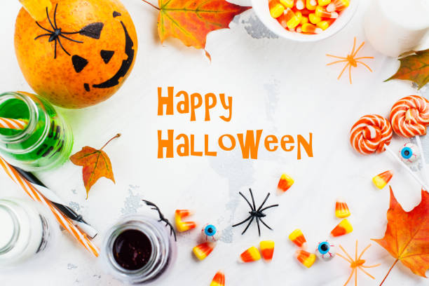 istock Halloween greeting card - drinks, candies and decor on white background 857340812