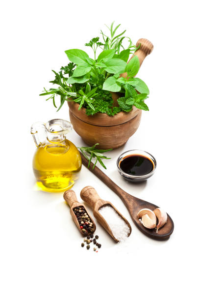 herbs in mortar, olive oil, balsamic vinegar, salt, pepper and galic isolated on white background - mortar and pestle condiment isolated food imagens e fotografias de stock