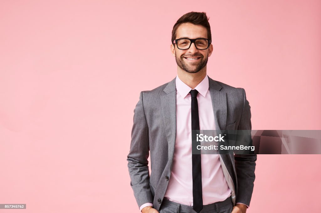 Happy grey suit guy Happy grey suit guy in pink studio, portrait Men Stock Photo