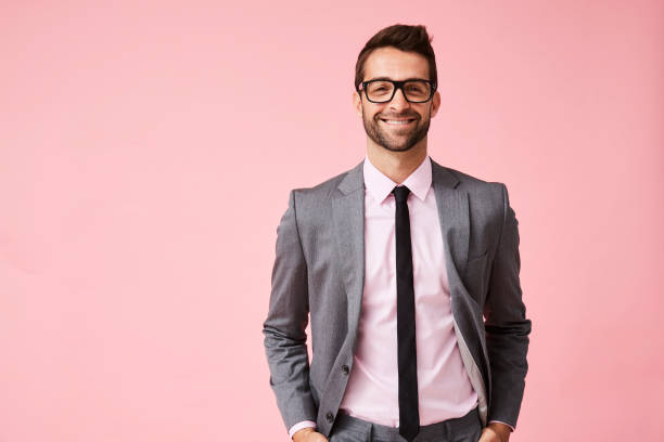 Happy grey suit guy Happy grey suit guy in pink studio, portrait business suit stock pictures, royalty-free photos & images