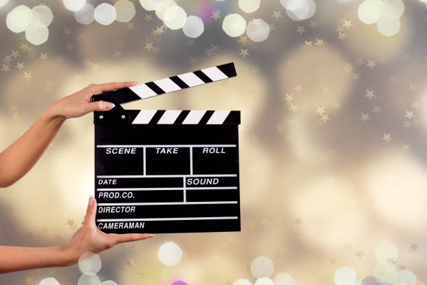 istock Clapperboard sign hold by female hands 857348000