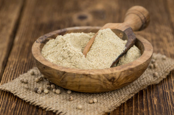 istock Portion of White Pepper on wooden background, selective focus 857349834