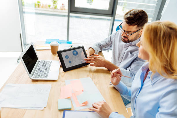 istock Attentive blonde looking at diagram 857354814