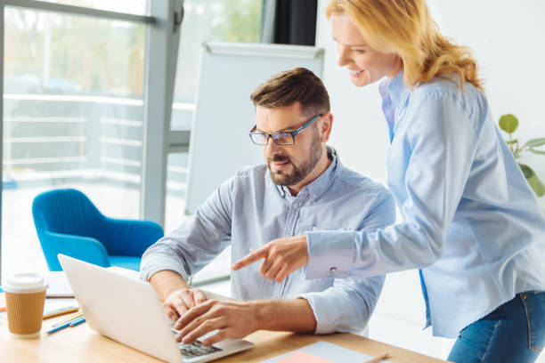 istock Concentrated man helping his colleague 857357542