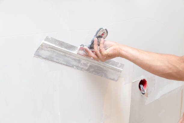istock the worker plastered the mortar on the wall 857360704