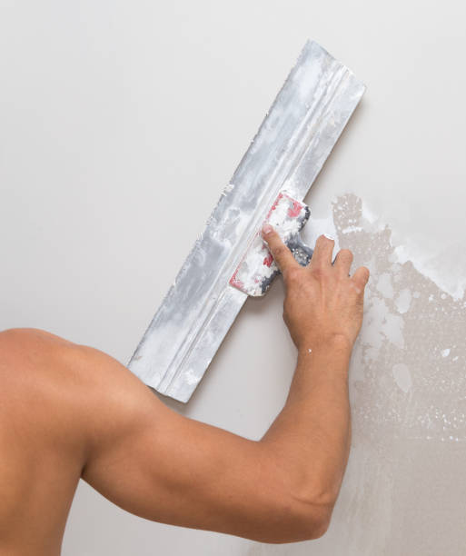 istock the worker plastered the mortar on the wall 857360786