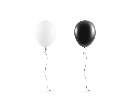 Black balloons floating in mid-air against black curtain with copy space. \nBlack Friday Concept.