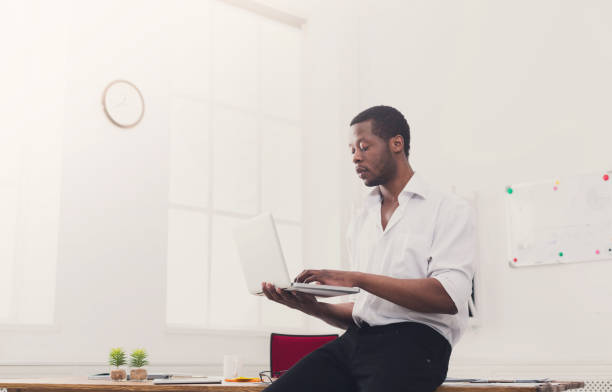 istock Concentrated black businessman in casual office, work with lapto 857370774