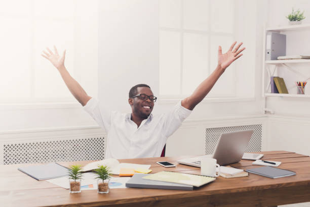 istock Happy businessman win. Winner, black man in office 857370898