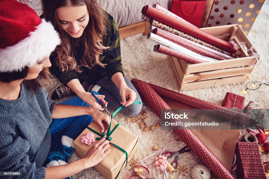 Ragazze che preparano un regalo per Natale - Foto stock royalty-free di Regalo di Natale