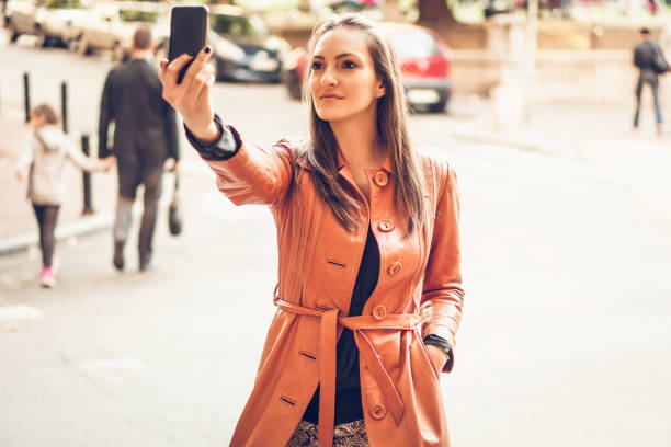 istock Woman using phone on the street 857376950