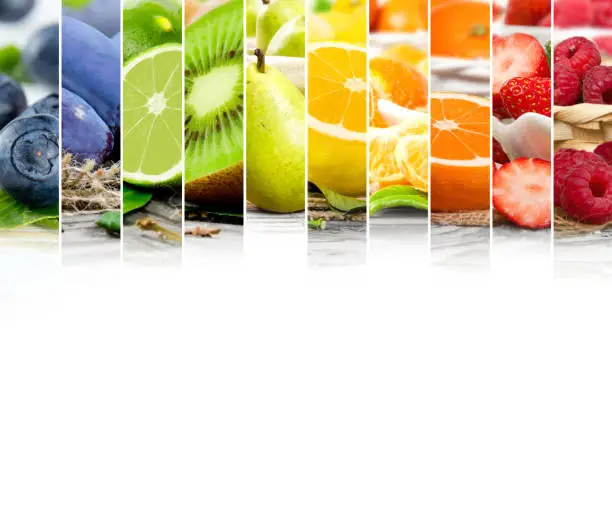 Photo of rainbow colorful mix stripes with fruit and slices; healthy eating concept; white space for text