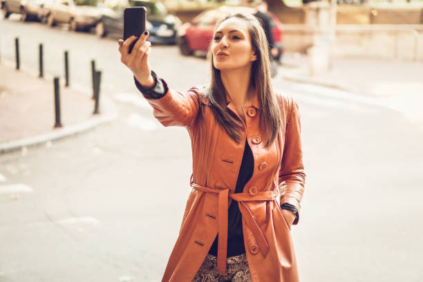 istock Woman using phone on the street 857377712