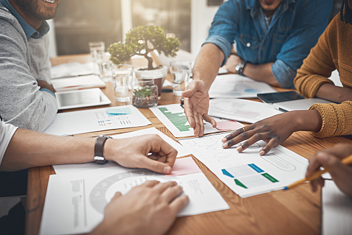 Shot of a group of businesspeople discussing statistics