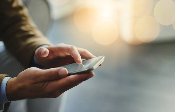 Wireless is the way to go High angle shot of an unrecognizable businessman using a mobile phone mobile phone stock pictures, royalty-free photos & images