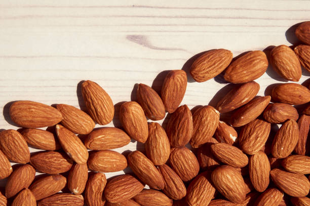istock Almonds are placed on a white wooden floor. 857388102