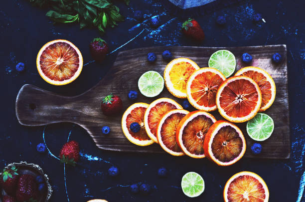 istock Bloody oranges and limes on dark background 857389276