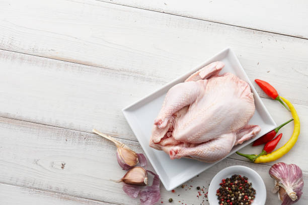 istock Raw chicken, herbs and spices on white wooden background 857389338