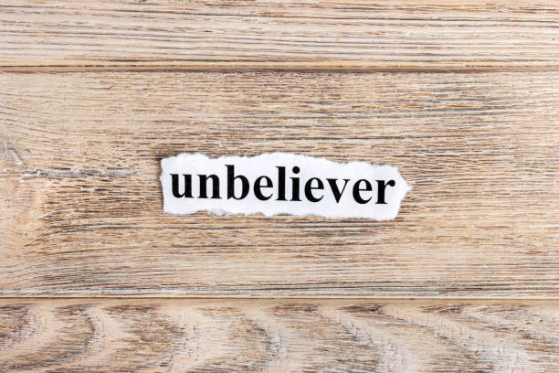 istock unbeliever text on paper. Word unbeliever on torn paper. Concept Image 857393294
