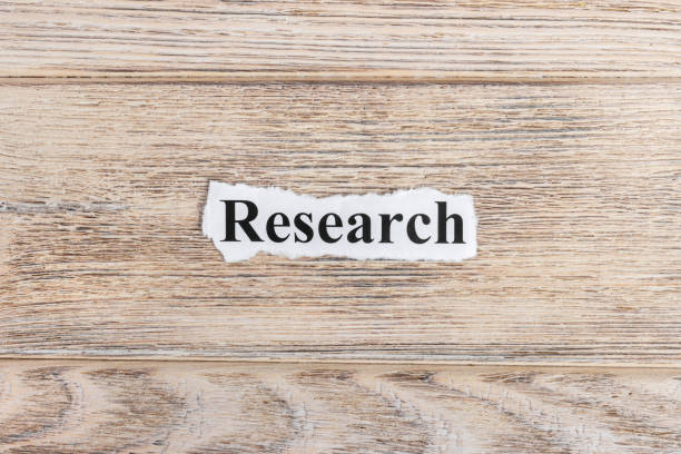 istock research text on paper. Word research on torn paper. Concept Image 857393306
