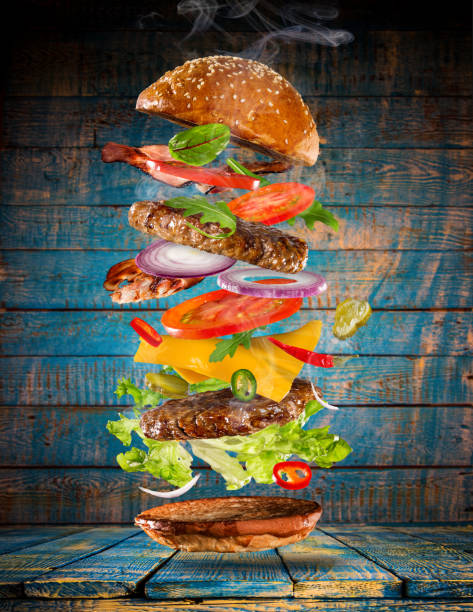 istock Big tasty burger with flying ingredients 857401574