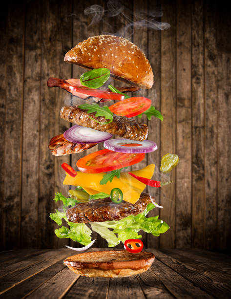 istock Big tasty burger with flying ingredients 857401608
