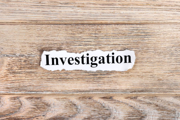 istock Investigation text on paper. Word Investigation on torn paper. Concept Image 857401840