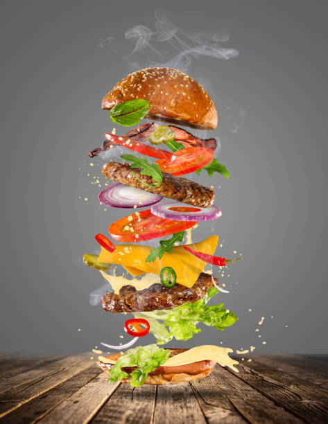 istock Big tasty burger with flying ingredients 857401872