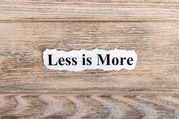 istock less is more text on paper. Word less is more on torn paper. Concept Image 857403148