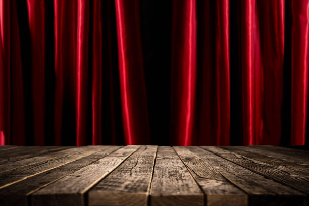 istock Red curtains and old wooden table 857403156
