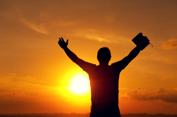 istock Silhouette of relaxed man enjoying sunset time 857403678