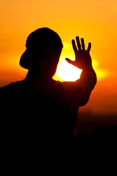 istock Silhouette of relaxed man enjoying sunset time 857404554