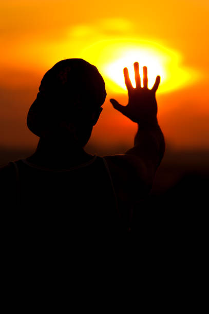 istock Silhouette of relaxed man enjoying sunset time 857404592