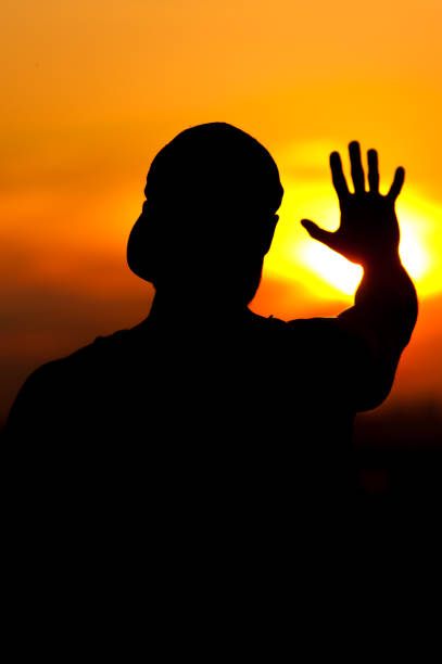 istock Silhouette of relaxed man enjoying sunset time 857405650