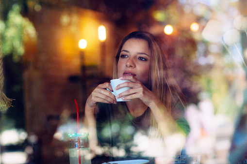 Portrait of  beautiful young women sitting at the cafe