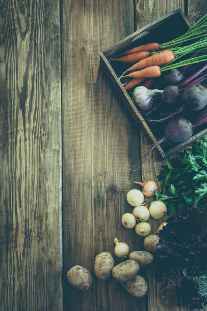 istock Harvest fresh vegetables from carrot, beetroot, onion, garlic on old wooden board. Top view, rustic style. Autumn still life. Gardening. Copy space. 857407952