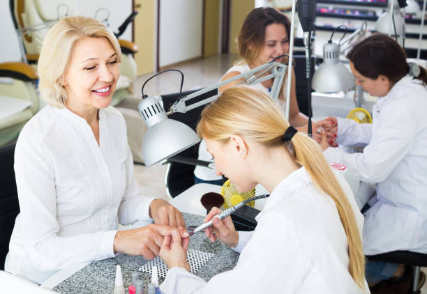 istock Female clients doing nails in nail salon in afternoon 857411692