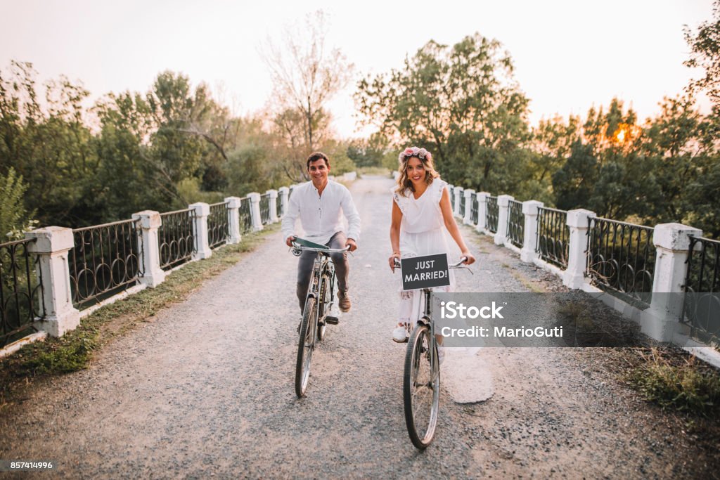 Just married couple in bikes A just married couple riding their bikes after getting married. Wedding Stock Photo