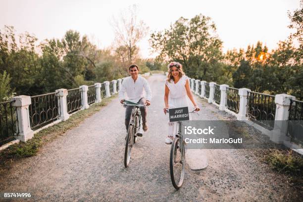 Just Married Couple In Bikes Stock Photo - Download Image Now - Wedding, Newlywed, Bicycle