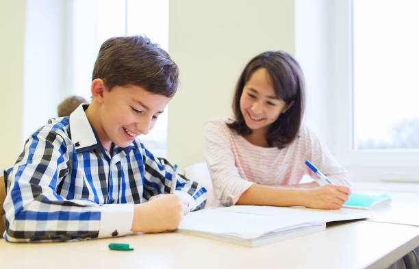 istock group of school kids writing test in classroom 857418800