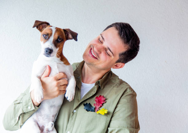 istock Handsome man with dog and oak leaves 857418958