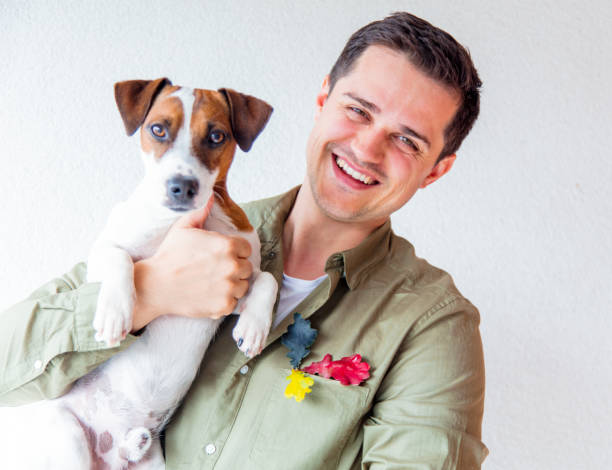 istock Handsome man with dog and oak leaves 857418998