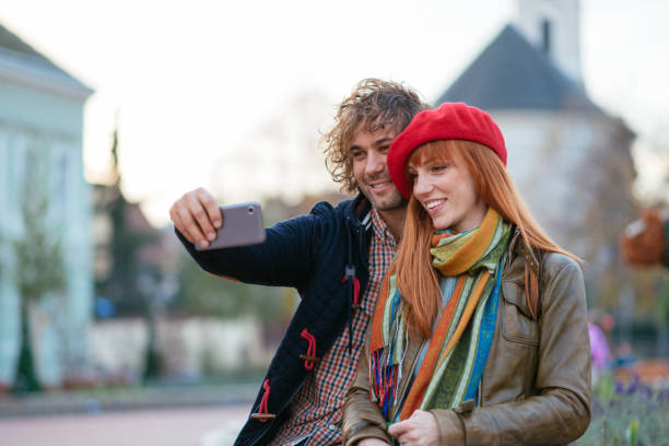 istock Beautiful couple in downtown taking selfie 857419360