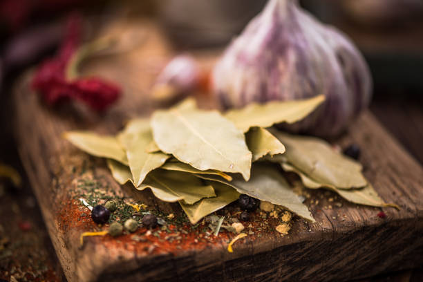 Dried bay leaf on spicy wooden board.