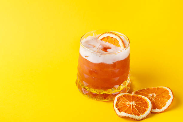 istock Orange cocktail with citron on colorful background 857422986