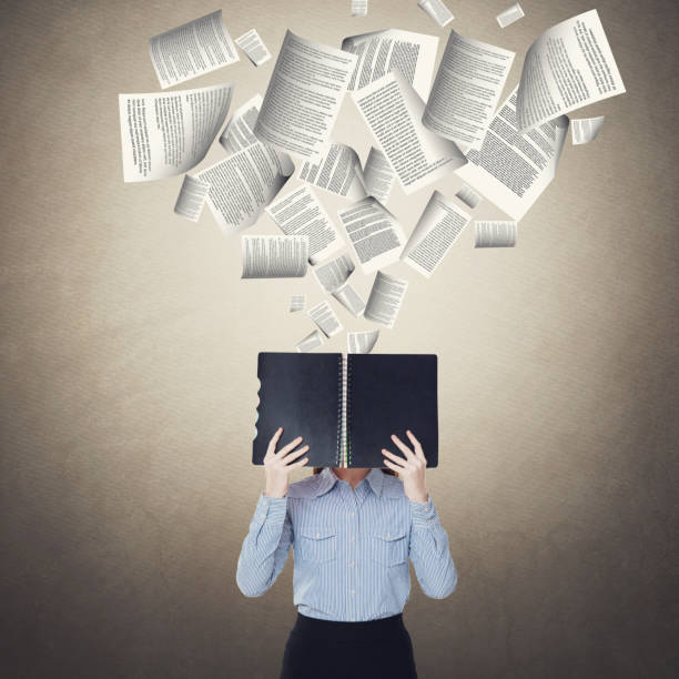istock Businesswoman holding diary with flying documents 857423232
