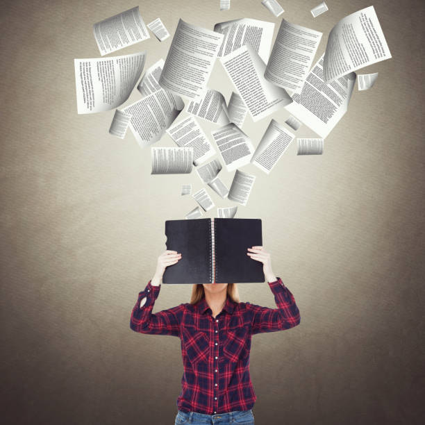 istock Businesswoman holding diary with flying documents 857423328