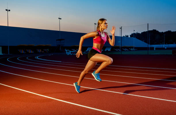Runner sprinting towards success on run path running athletic track. Goal achievement concept