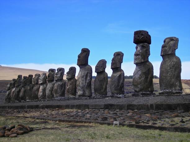 Row of Mo'ai Statues - Easter Island Easter Island, Chile, 31st December 2004.  In this picture, are a  row of Mo'ai statues on a stone plinth with bodies (as opposed to just heads/busts), one of which still has its hat (topping). mcdermp stock pictures, royalty-free photos & images