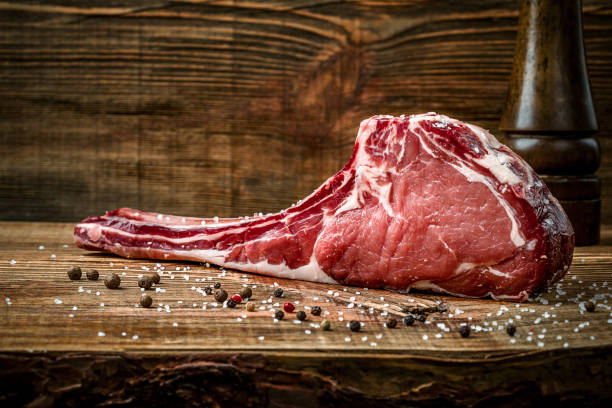 istock Dry aged raw tomahawk beef steak with ingredients for grilling 857432968